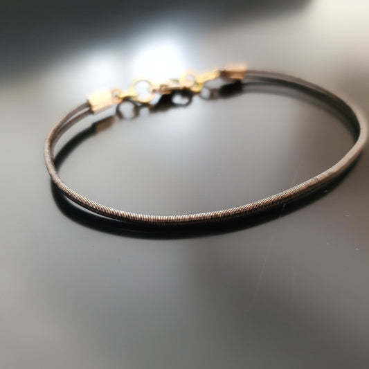 brown clasp style bracelet made from an upcycled harp string