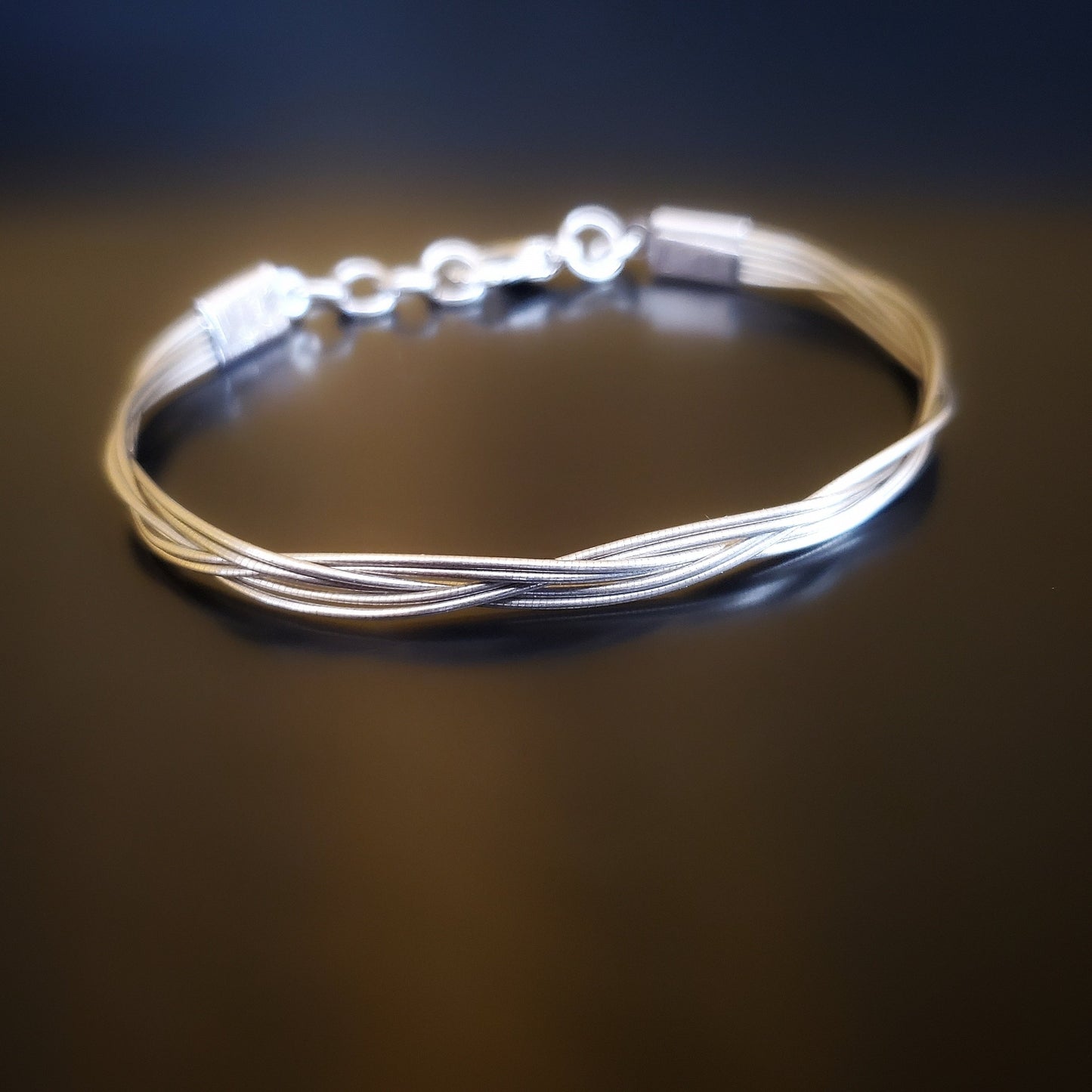 upcycled cello string unisex silver bracelet black background