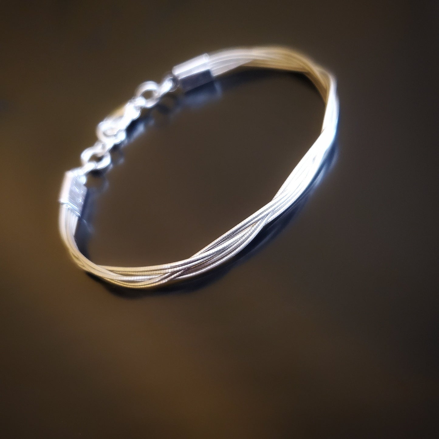 upcycled cello string unisex silver bracelet black background