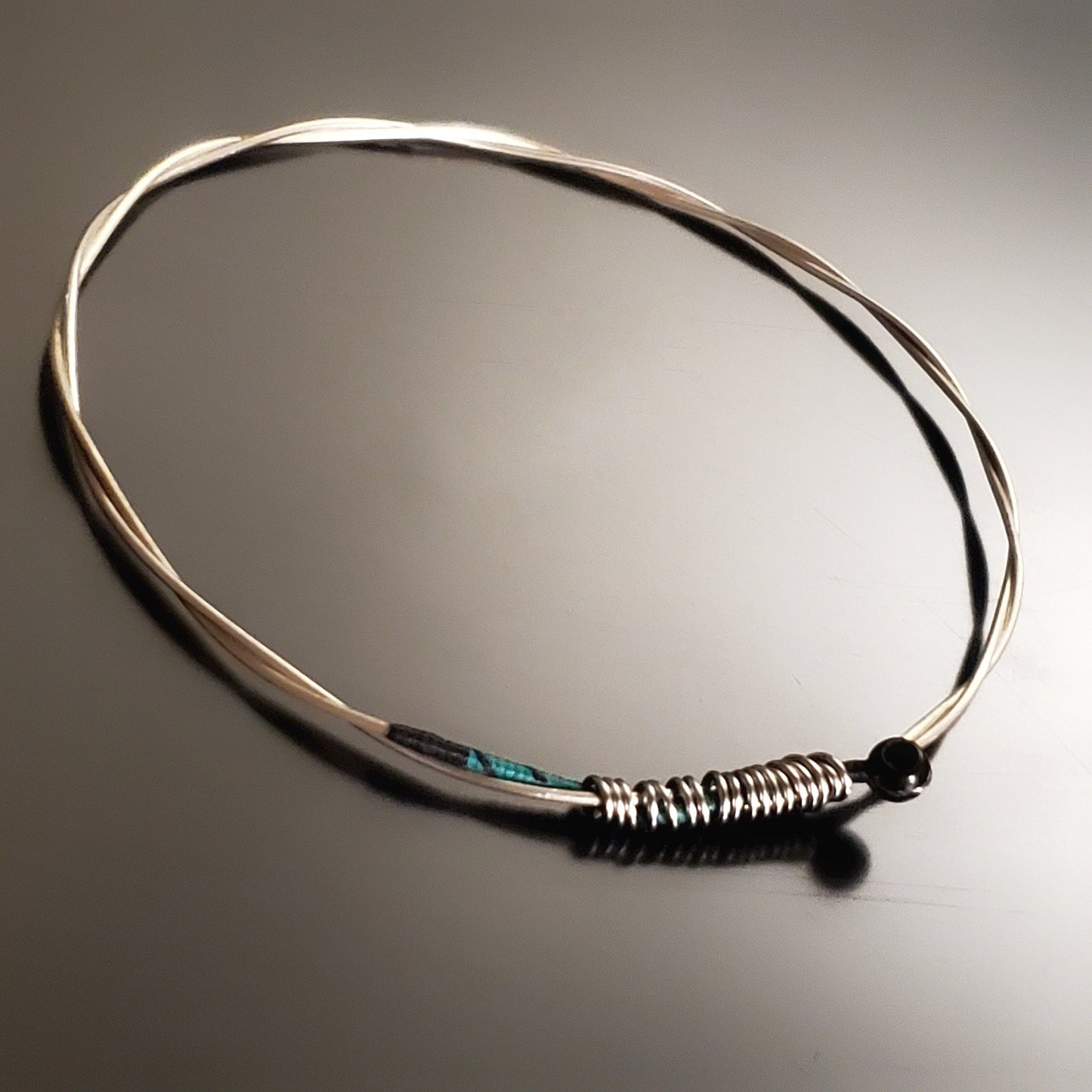 bangle style bracelet made from an upcycled violin