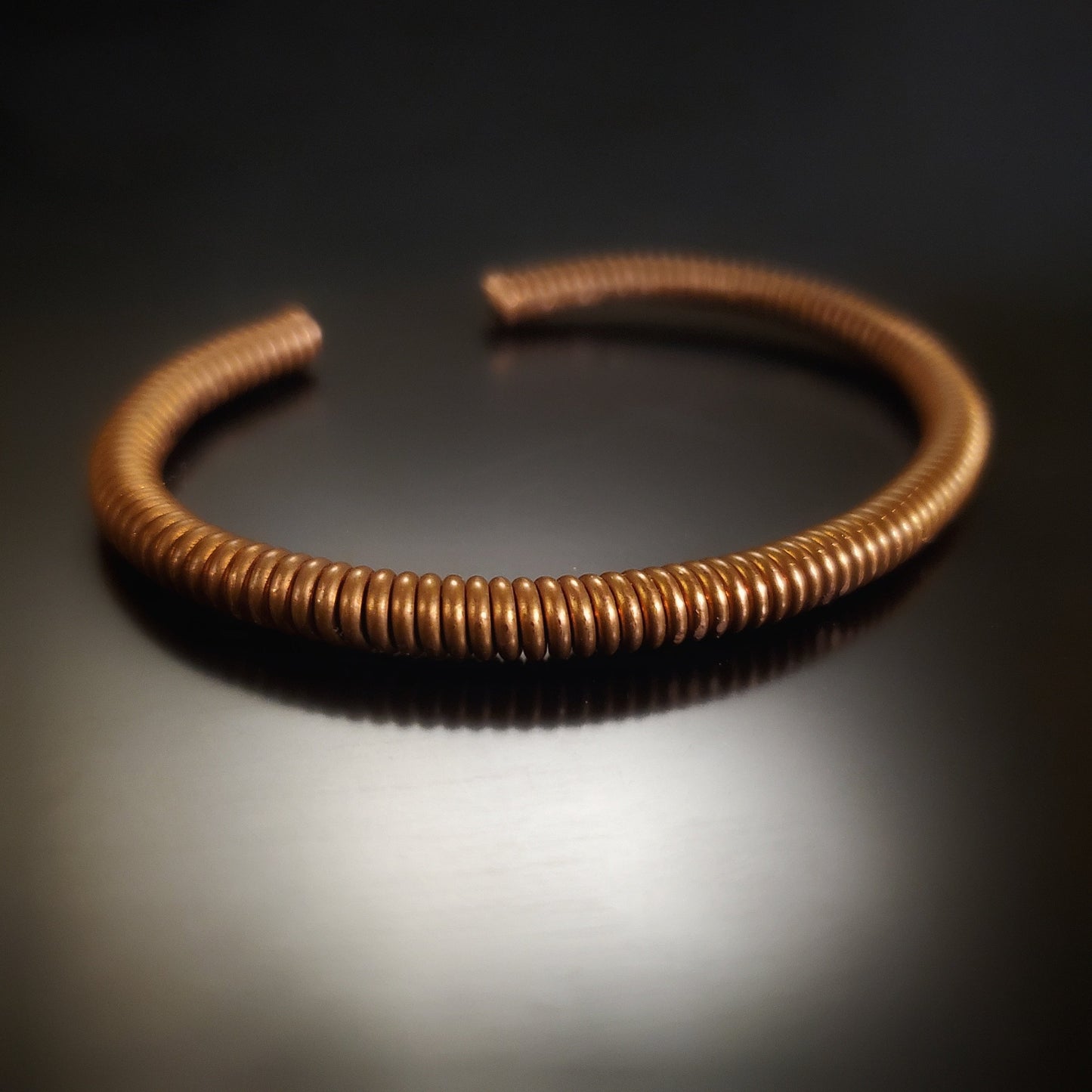 copper cuff style bracelet made from an upcycled piano string