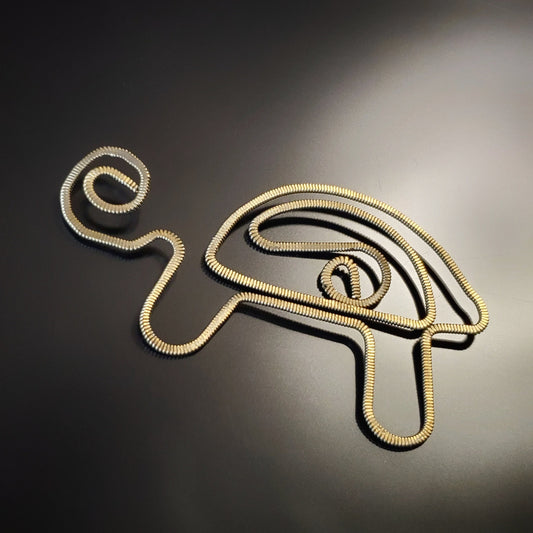 bookmark in the shape of a turtle made from upcycled hammered guitar strings