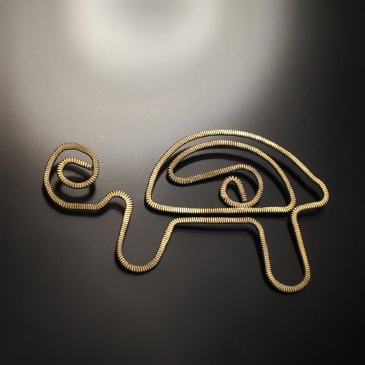 bookmark in the shape of a turtle made from upcycled hammered guitar strings