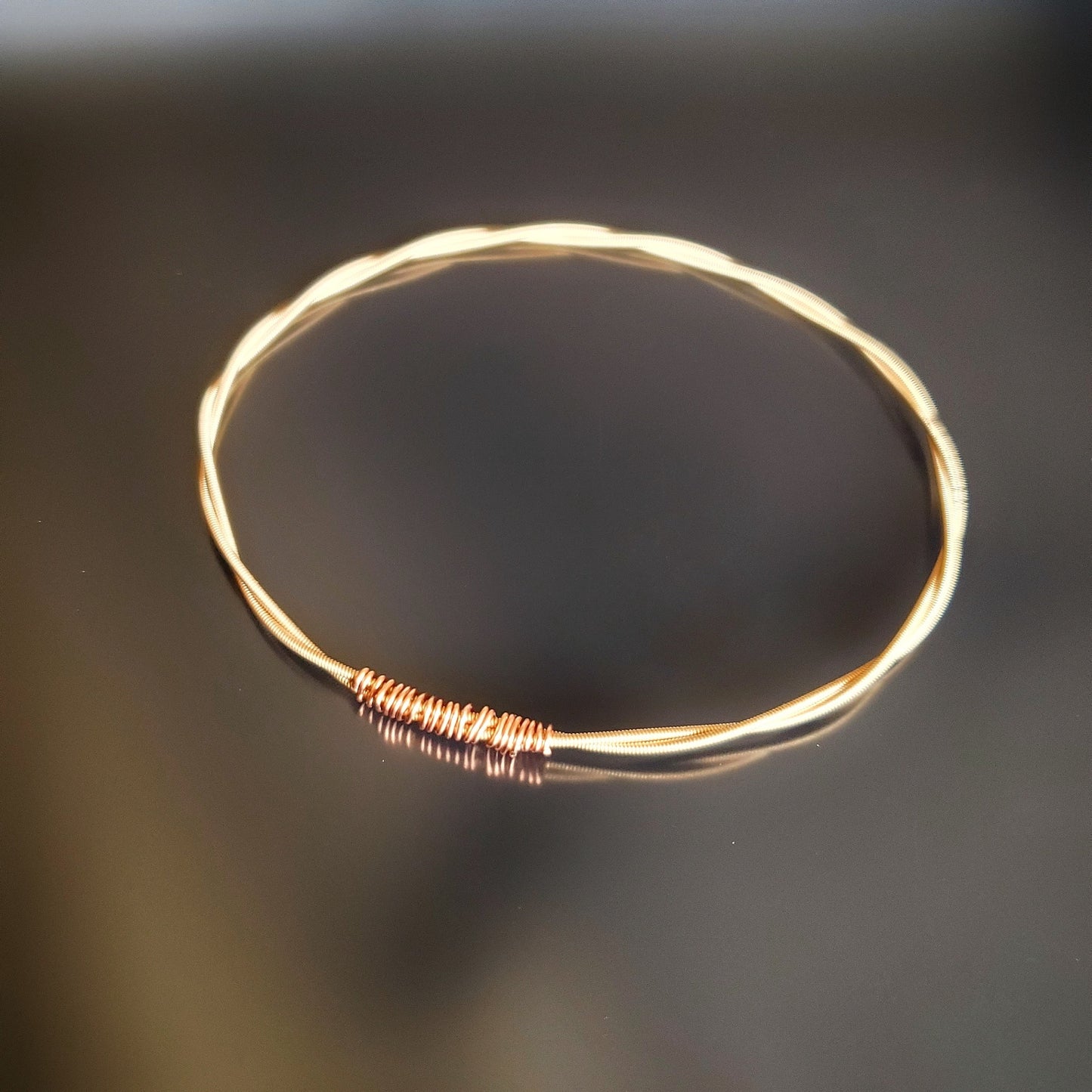 bangle style bracelet made from an upcycled mandolin string