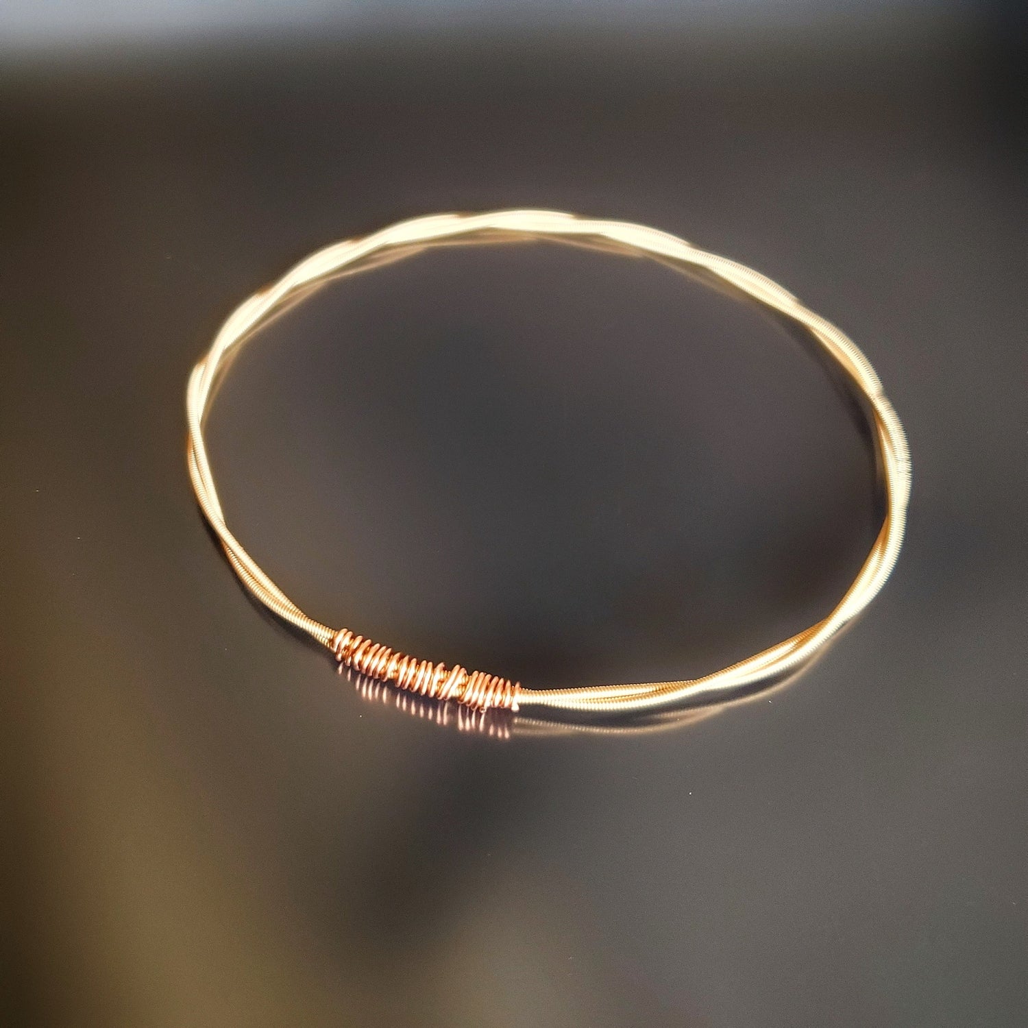 bangle style bracelet made from an upcycled mandolin string