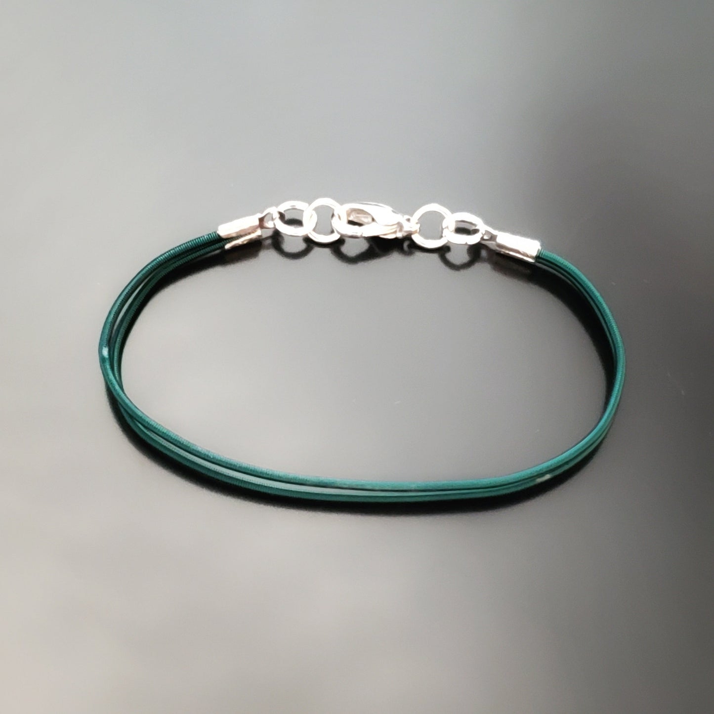 bracelet made from 2 upcycled green harp strings