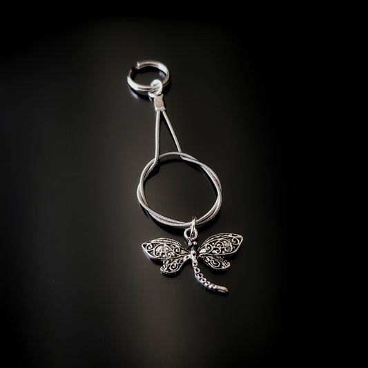 silver coloured keychain made from an upcycled guitar string on which hangs a silver coloured dragonfly pendant