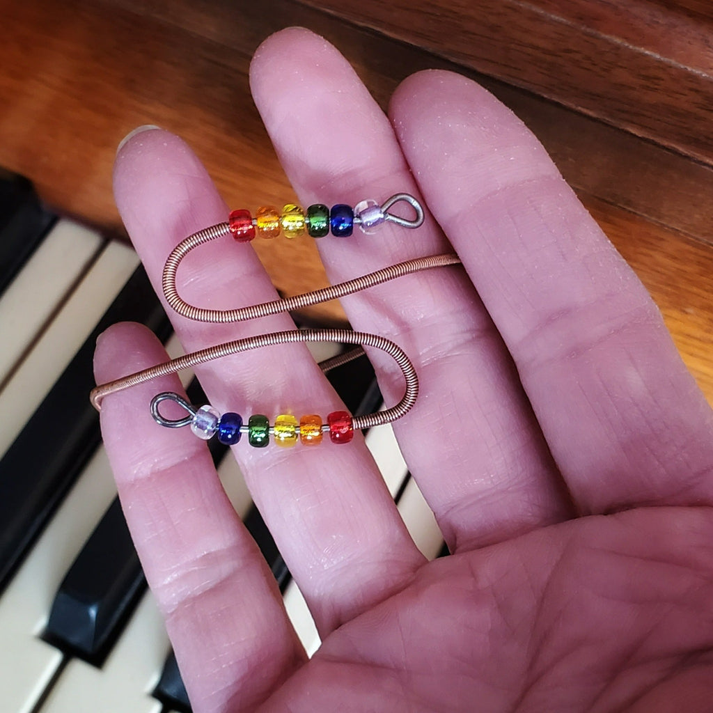 cuff style bracelet with beads representing sitting in a person's hand