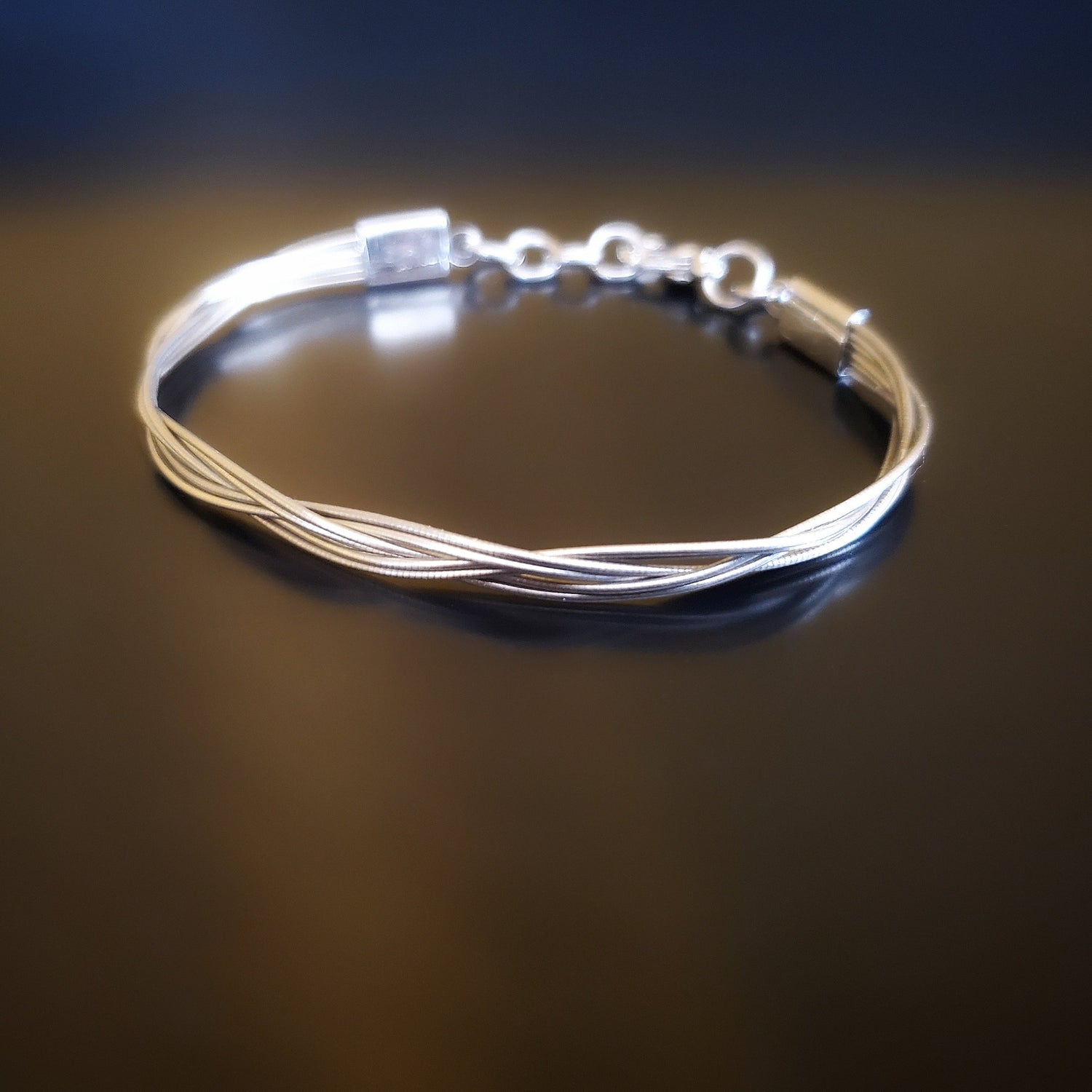 upcycled cello string unisex silver bracelet black background