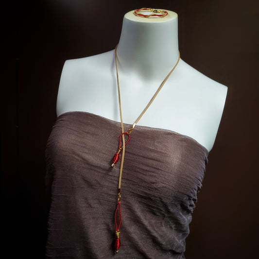 mannequin torso wearing an upcycled harp string and suede necklace and bracelet