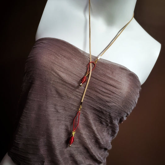 mannequin torso wearing an upcycled harp string and genuine suede necklace