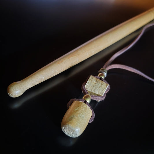 Upcycled Drumstick Tip and Piece and Suede Necklace lying next to a drumstick