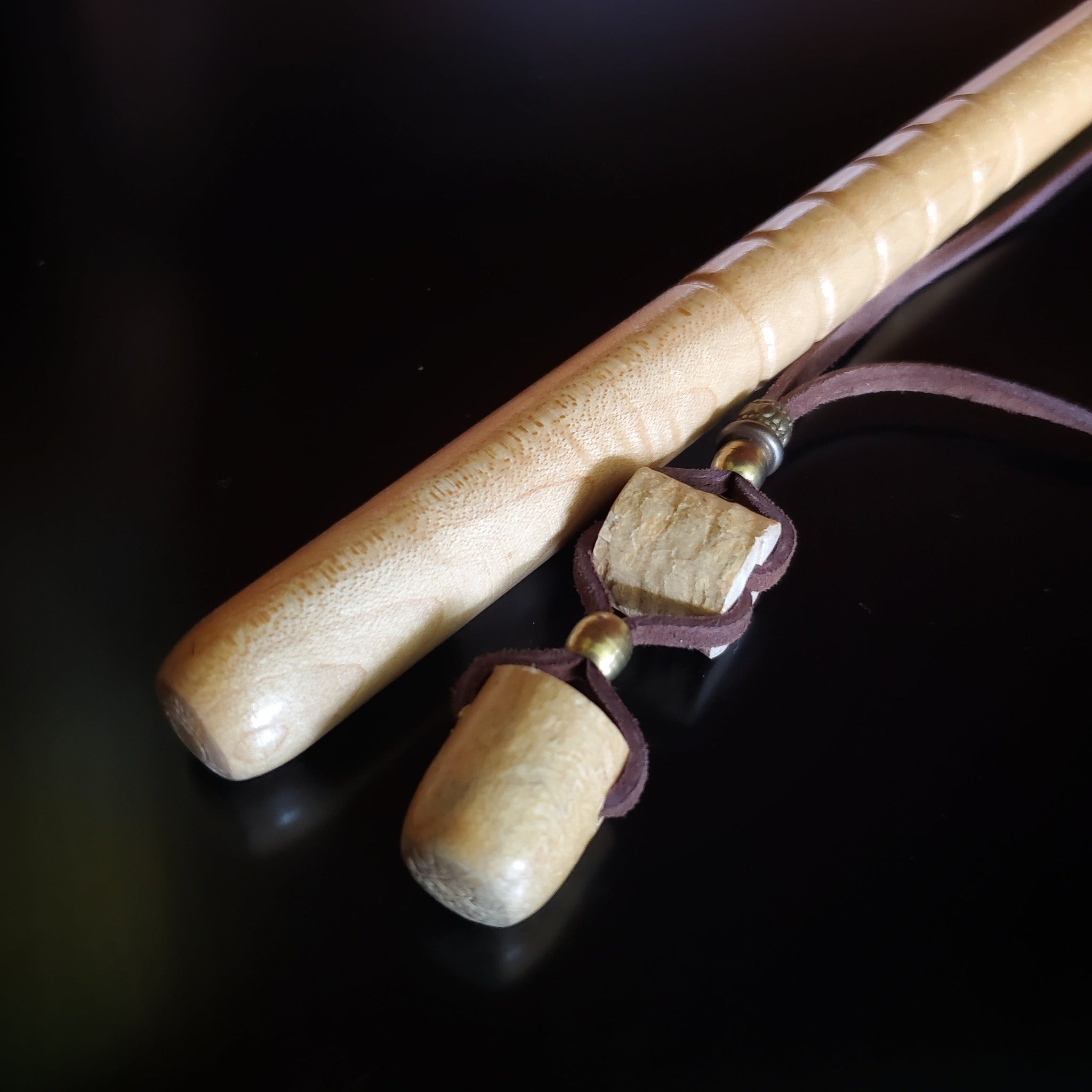 Upcycled Drumstick Tip and Piece and Suede Necklace lying next to a drumstick