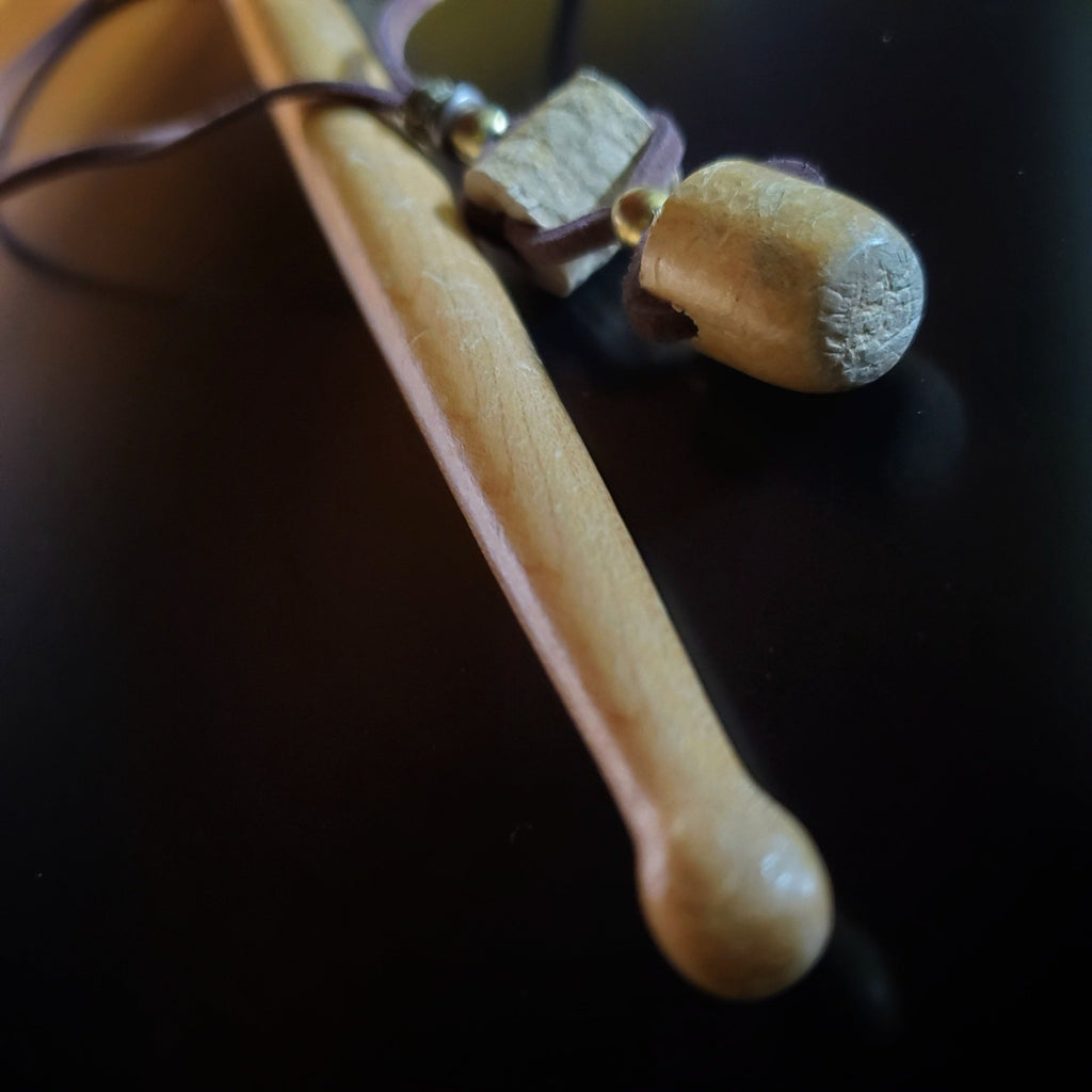 Upcycled Drumstick Tip and Piece and Suede Necklace lying next to a drumstick