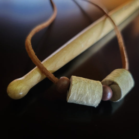 Upcycled Double Drumstick Beads and Brown Suede Necklace With Wooden Beads lying on a drumstick