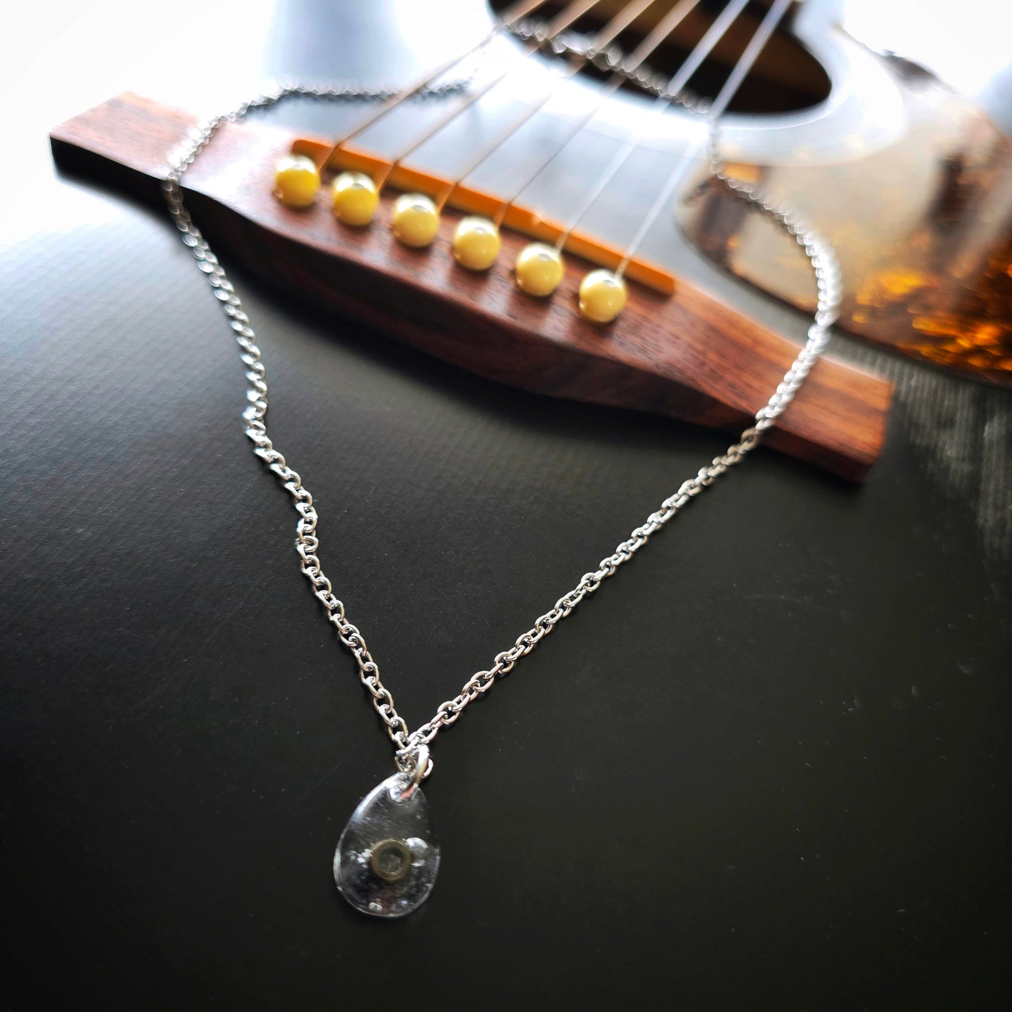 Black Ballend Teardrop Resin Necklace on Black Guitar