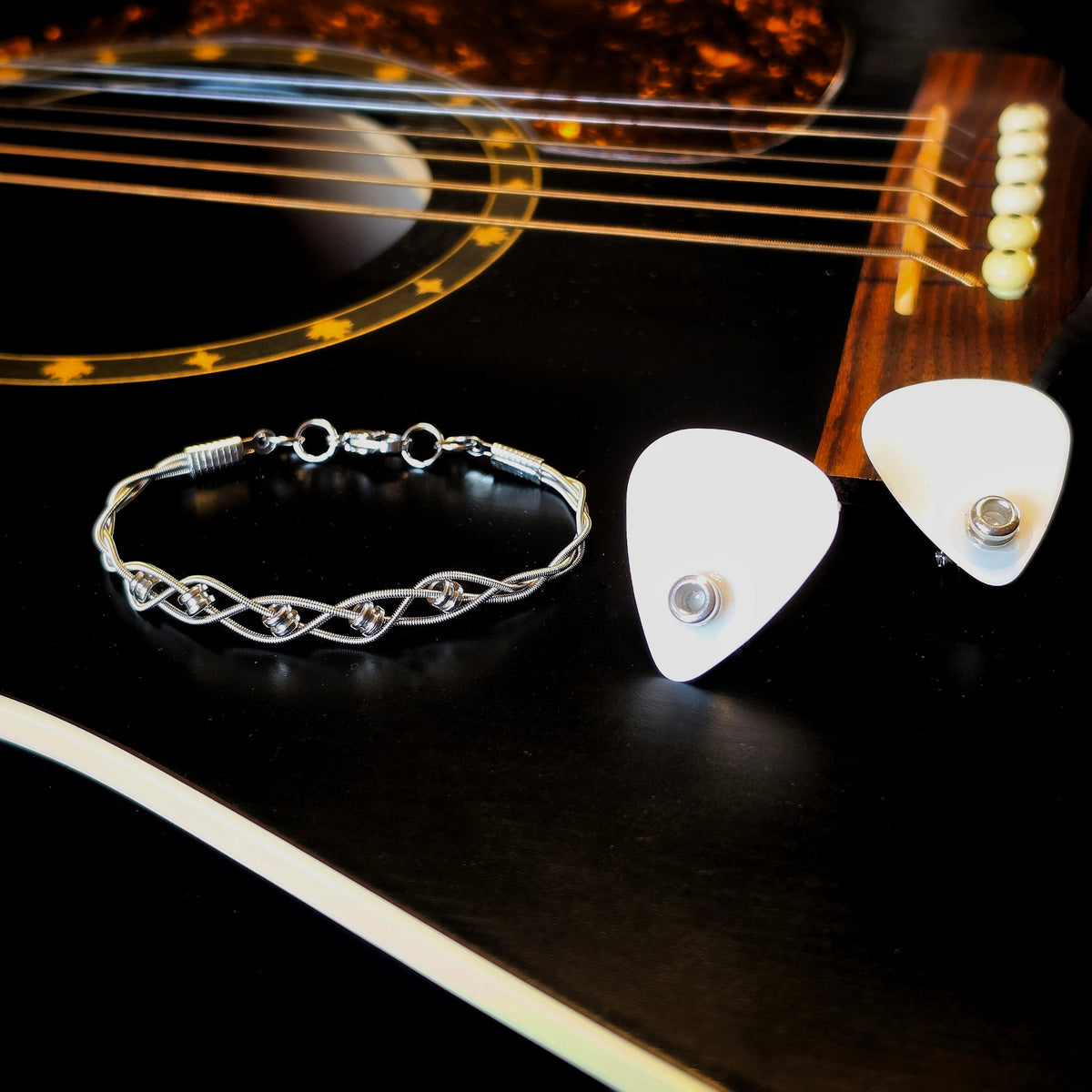 Braided Guitar String and Ballend Clasp Style Bracelet and Guitar Pick and Ballend Earrings Jewelry Set on Black Guitar