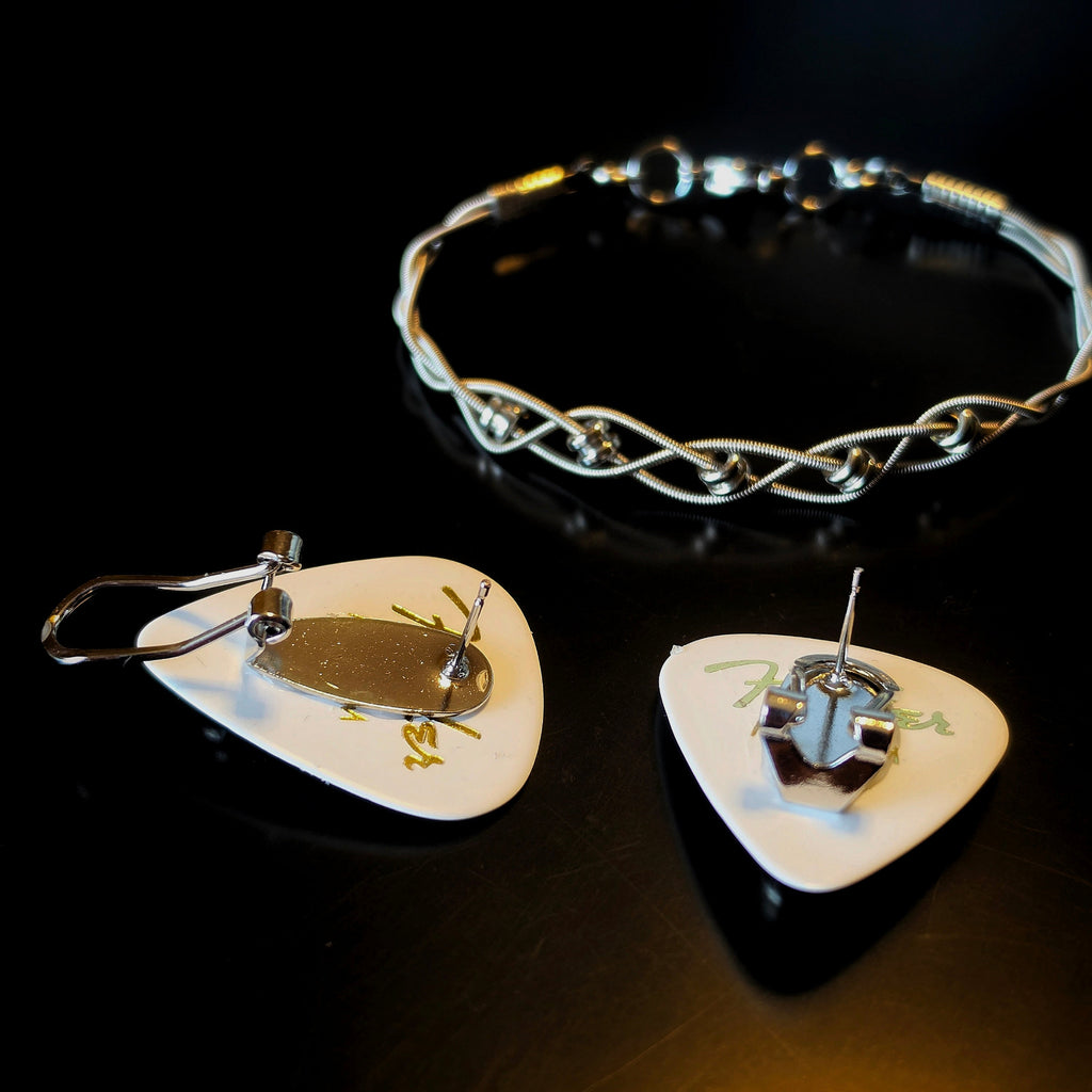 Braided Guitar String and Silver Coloured Ballend Clasp Style Bracelet and Guitar Pick and Ballend Earrings Jewelry Set on Dark Background - back view