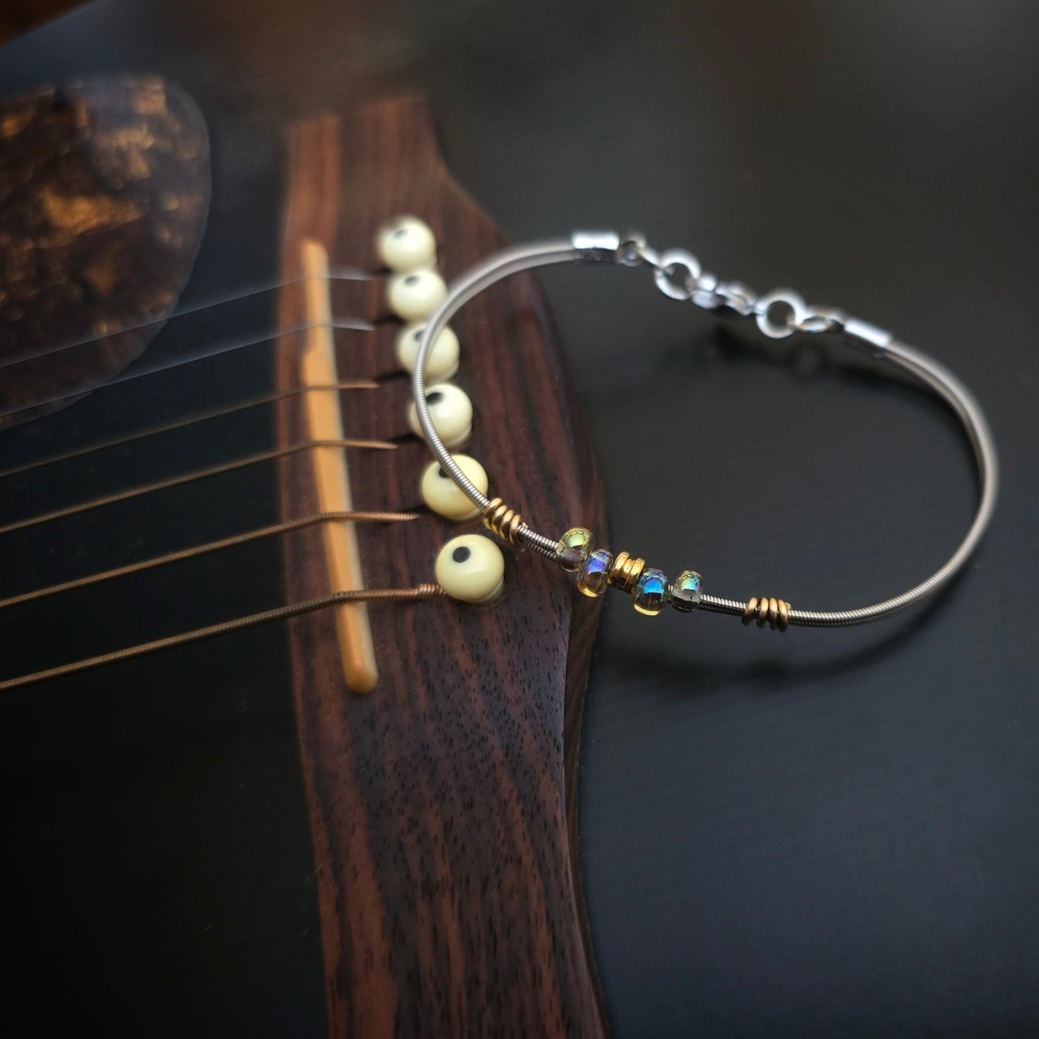 Bright beaded guitar string bracelet on guitar