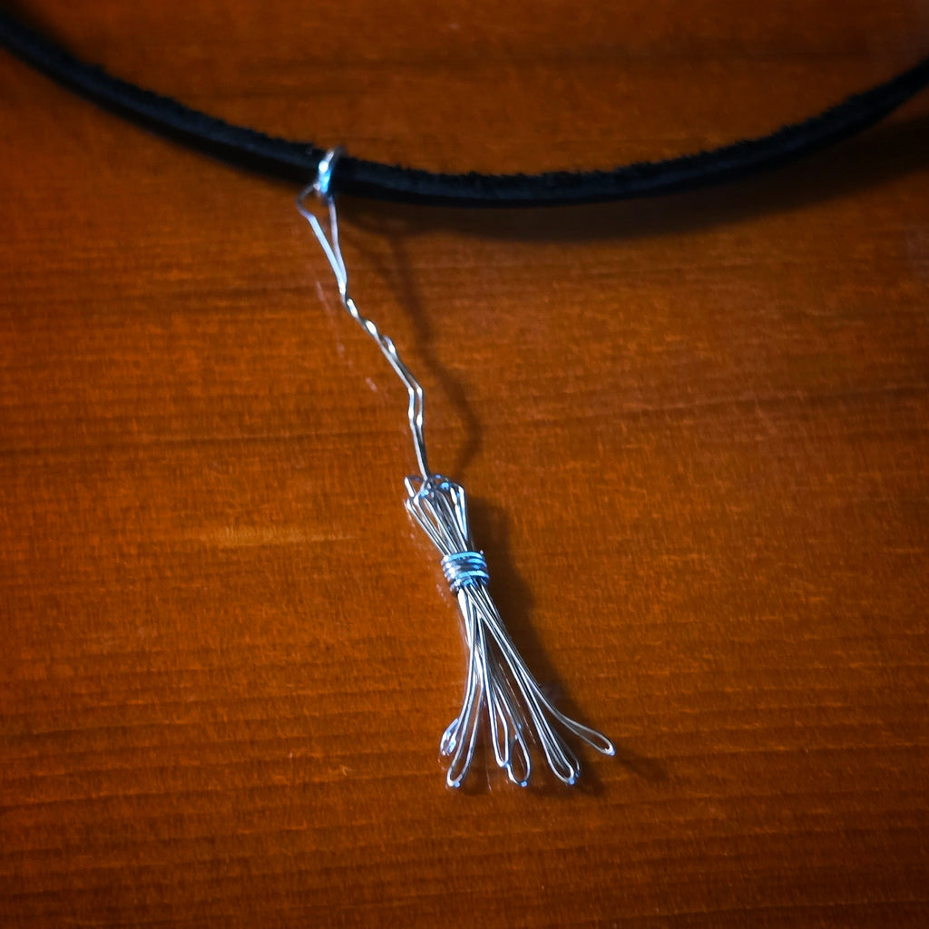 Close-up of Witch's Broom Guitar String and Black Leather Choker on Guitar