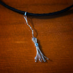 Close-up of Witch's Broom Guitar String and Black Leather Choker on Guitar
