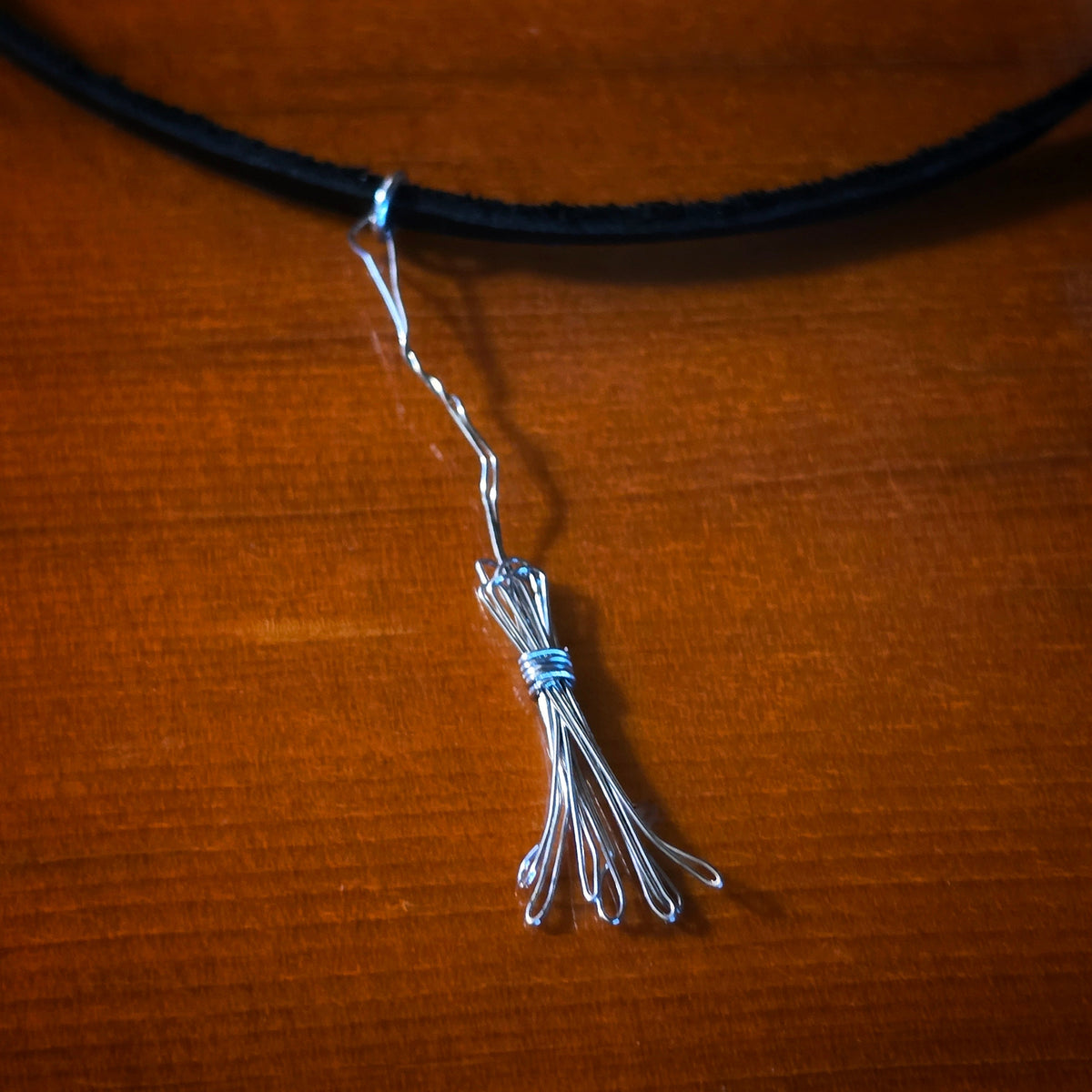 Close-up of Witch's Broom Guitar String and Black Leather Choker on Guitar