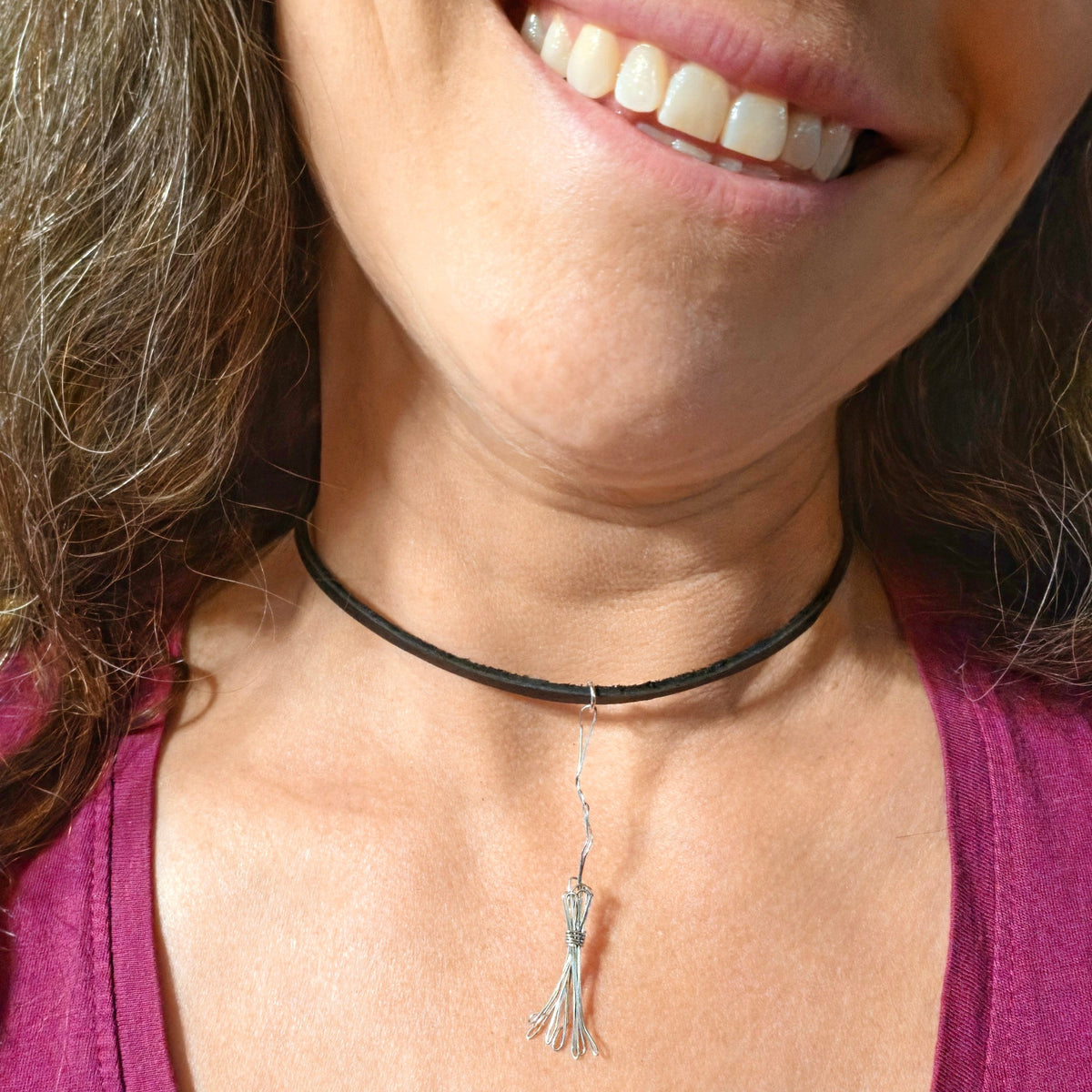 Close-up of Woman Wearing a Witch's Broom Guitar String and Leather Choker