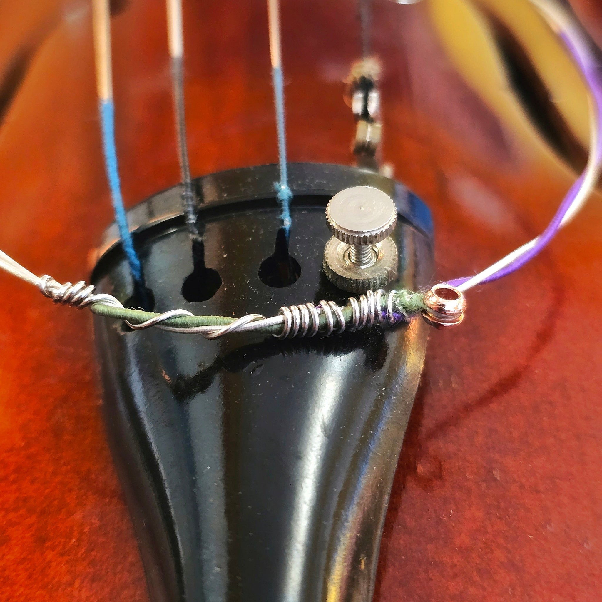 Closeup of green and purple violin string bangle