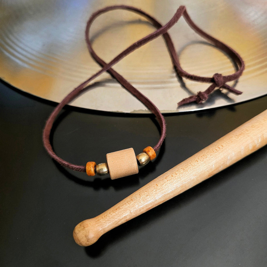 Drumstick and Brown Suede Necklace With Smooth Beads Drumstick and Cymbal in Background