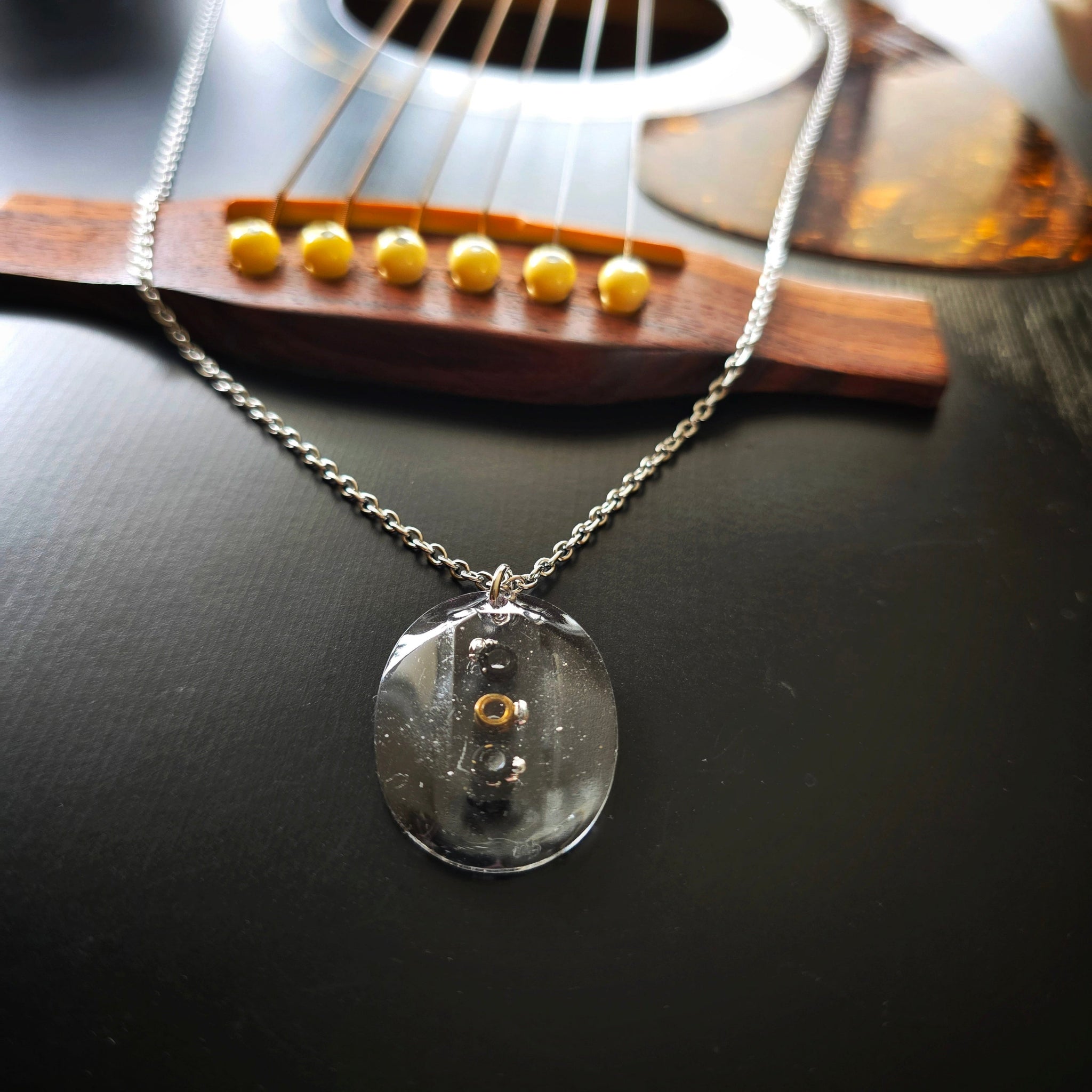 Front View Necklace with Oval Resin Pendant with Black Guitar String Ballends