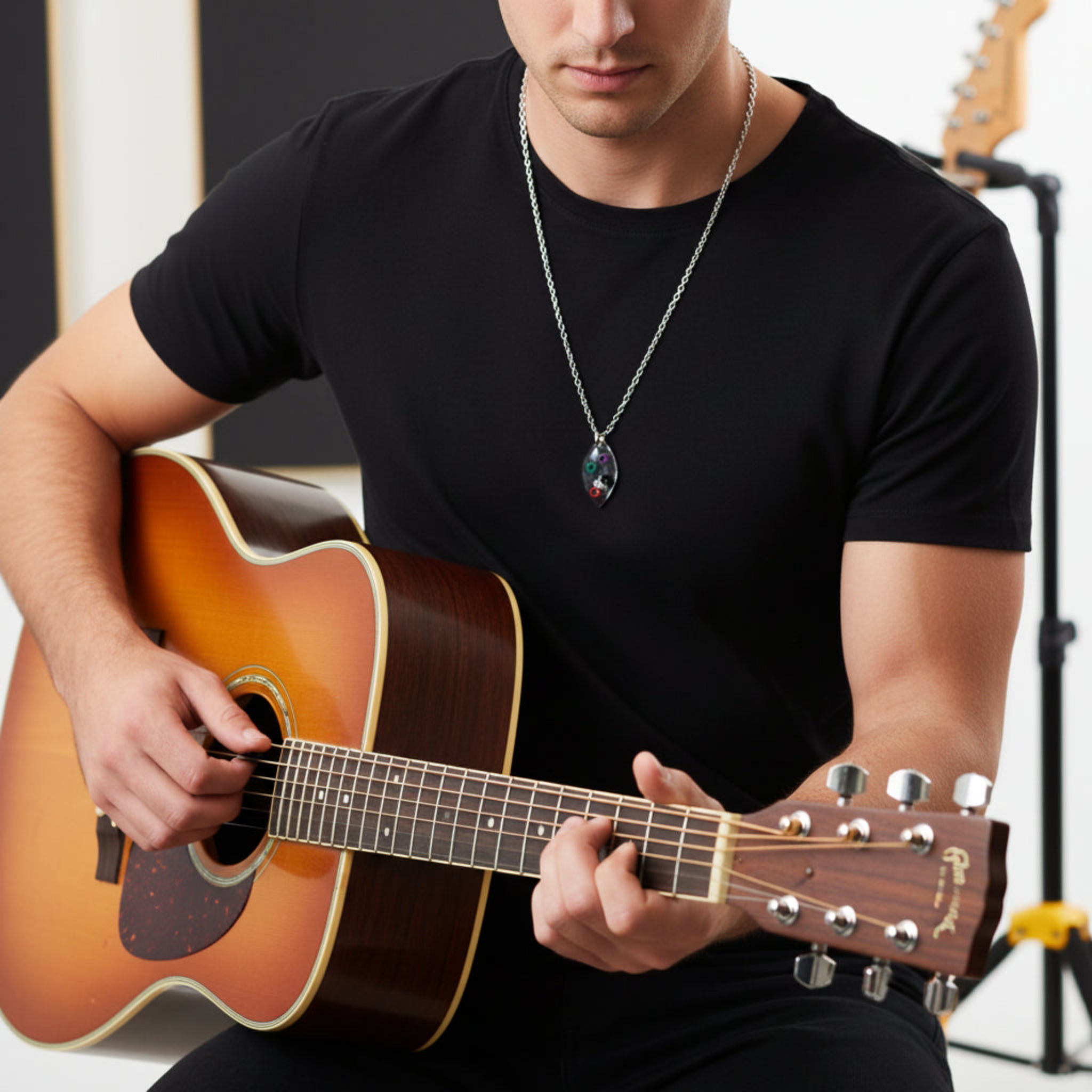 Guitar Player wearing Marquise Shaped Resin Pendant with Multicoloured Ballends Necklace on Black Guitar