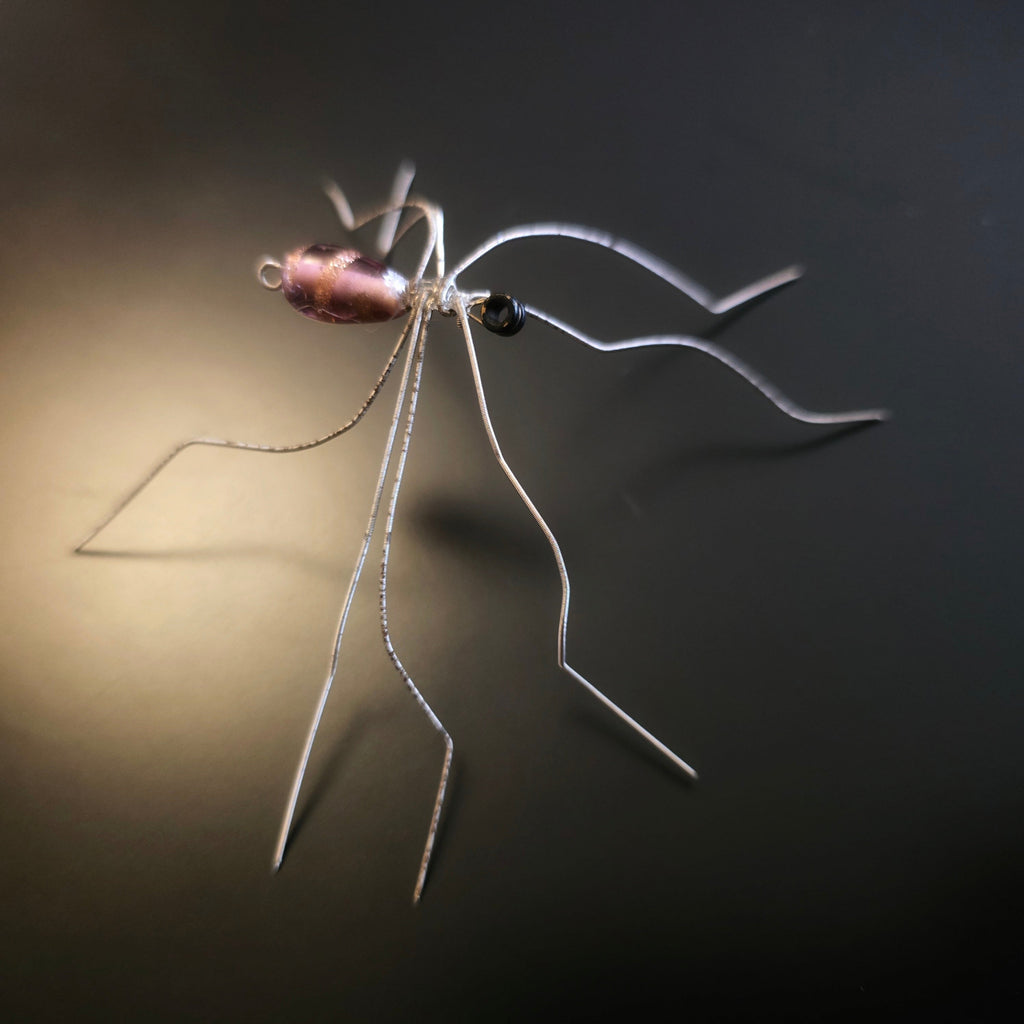 Guitar string spider with a dark background