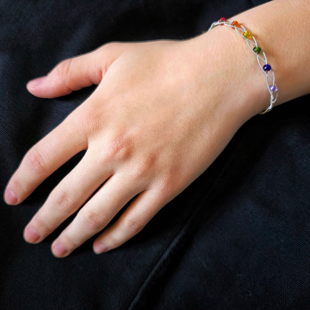 Hand Wearing LGBT Pride Bracelet with Braided Guitar Strings