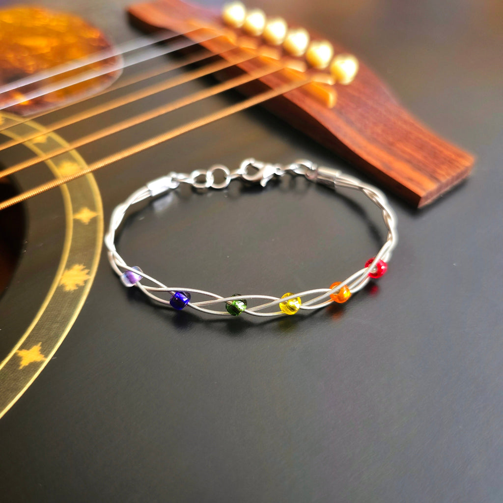 LGBT Pride Bracelet with Braided Guitar Strings on Black Guitar