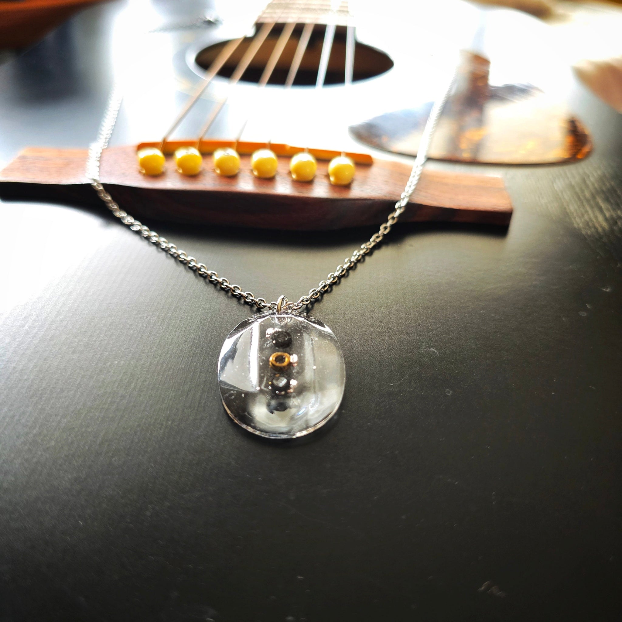 Necklace with Oval Resin Pendant with Black Guitar String Ballends