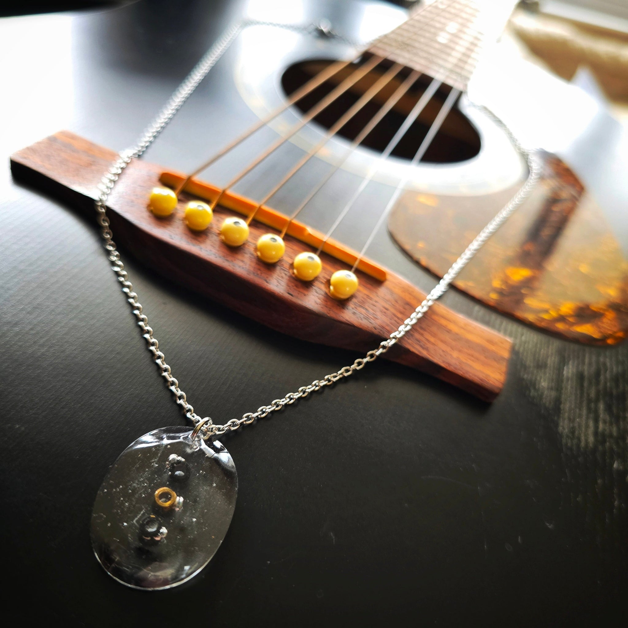 Necklace with Oval Resin Pendant with Black Guitar String Ballends on Black Guitar