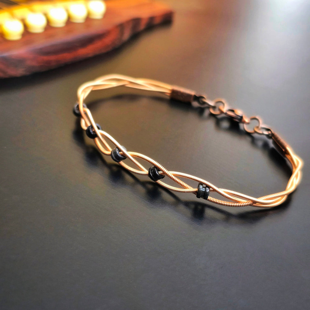 Side View Close-up Braided Bronze Guitar String Black Ballend Unisex Braceletrn