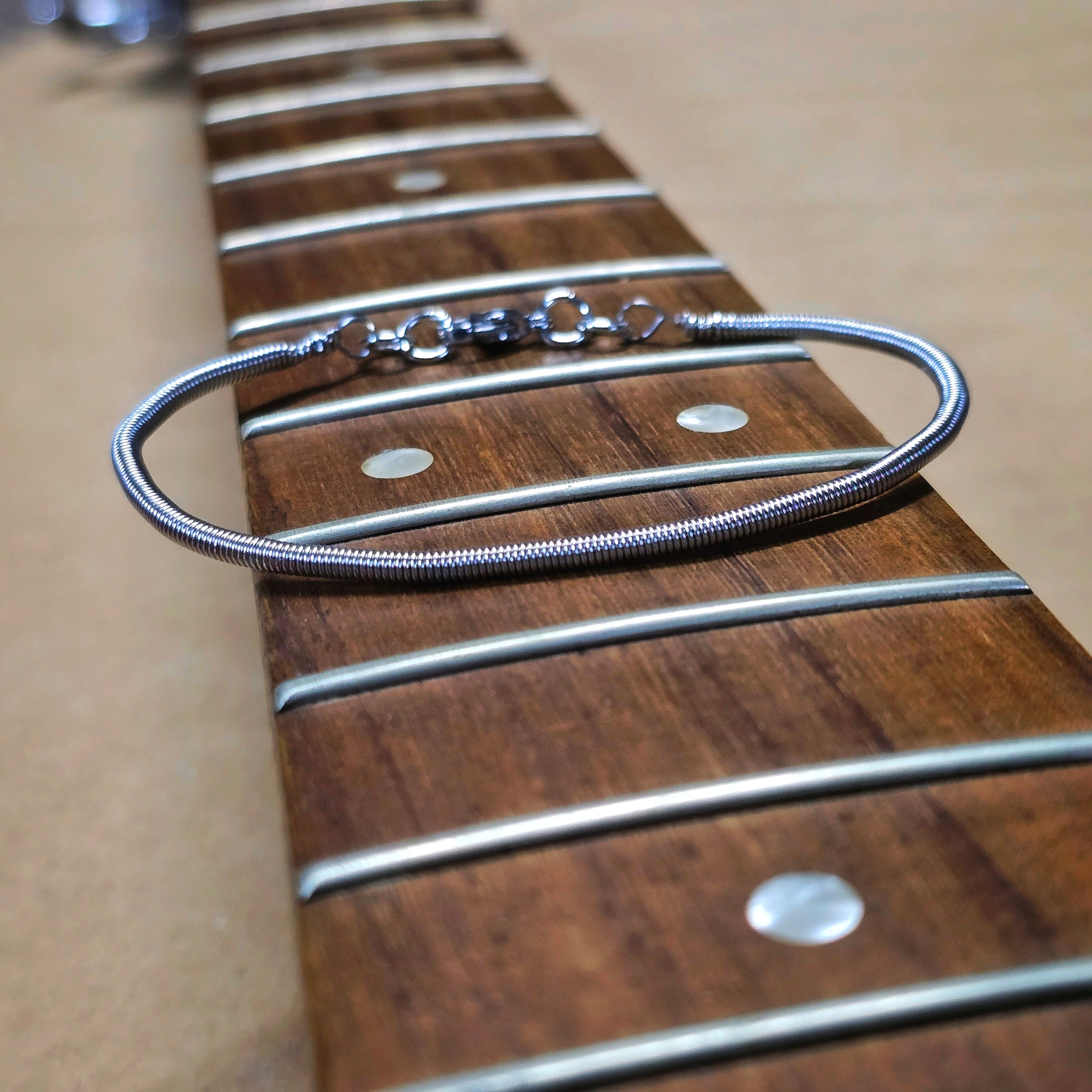 Simple Bass String Bracelet on Bass Guitar Neck
