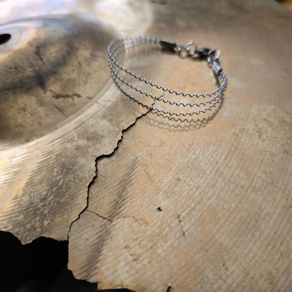 Upcycled 3 String Snare Drum Bracelet on Damaged Cymbal 