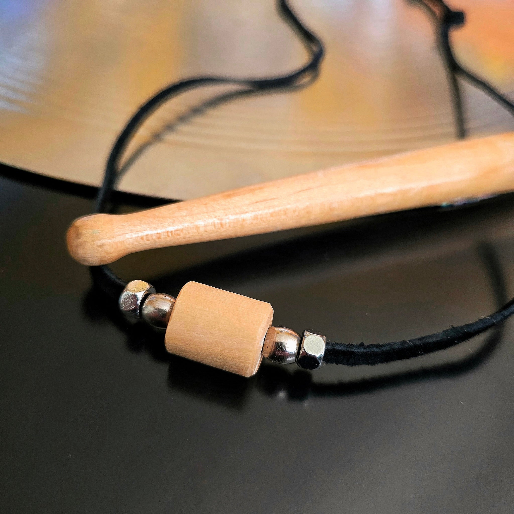 Upcycled Drumstick and Black Suede Necklace With Smooth Silver Beads Drumstick and Cymbal in Background