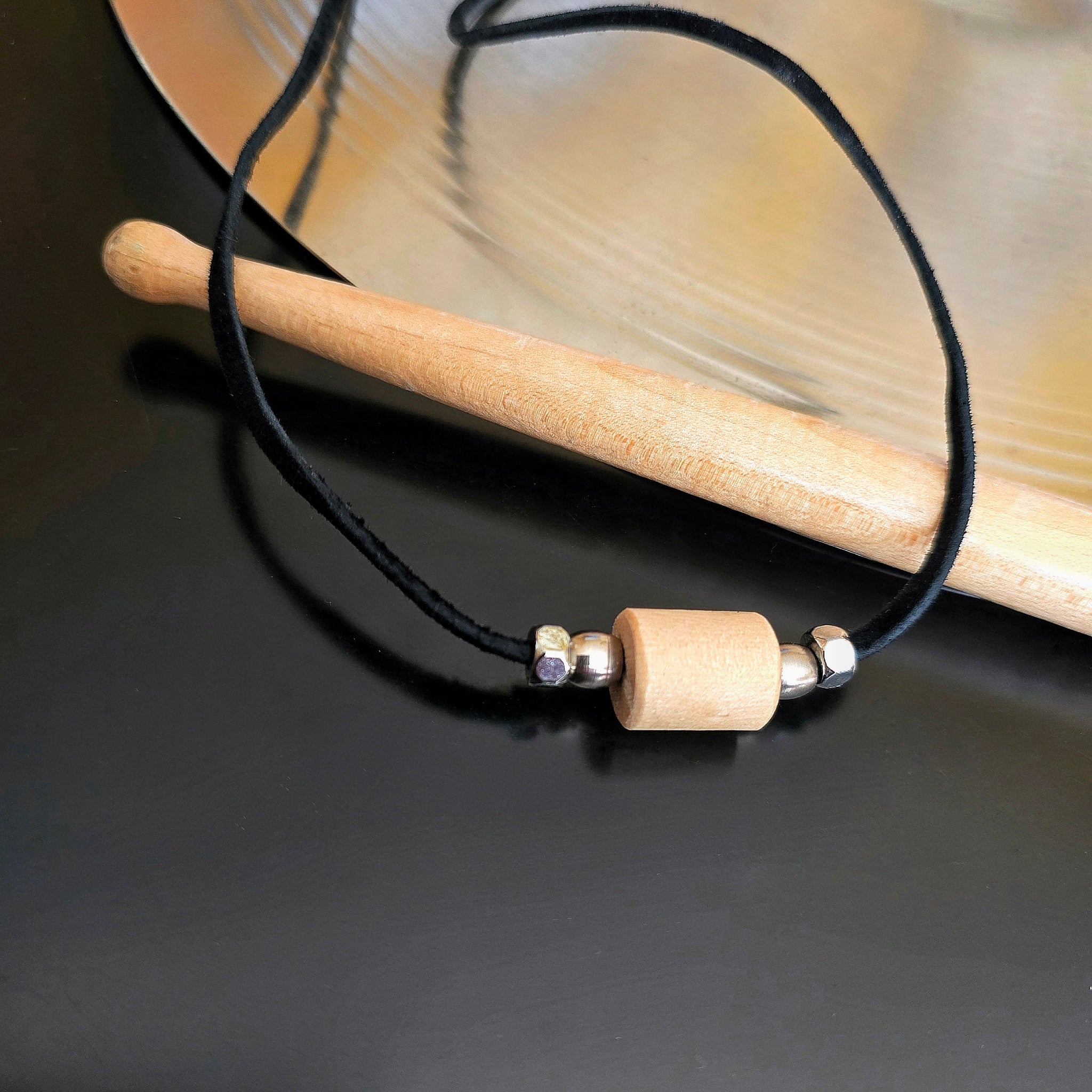 Upcycled Drumstick and Black Suede Necklace With Silver Beads Drumstick and Cymbal in Background