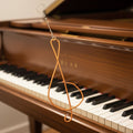 Upcycled Piano String Treble Clef Ornament with Piano in  Background