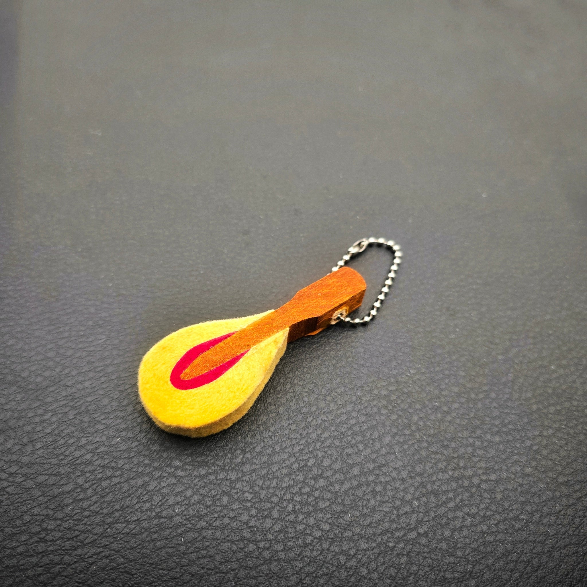 Upcycled Piano hammer essential oils diffuser on textured dark background