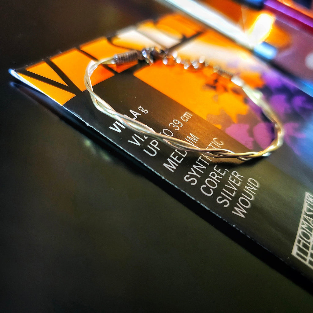 Upcycled Viola String Bracelet on Viola String Package and Dark Background