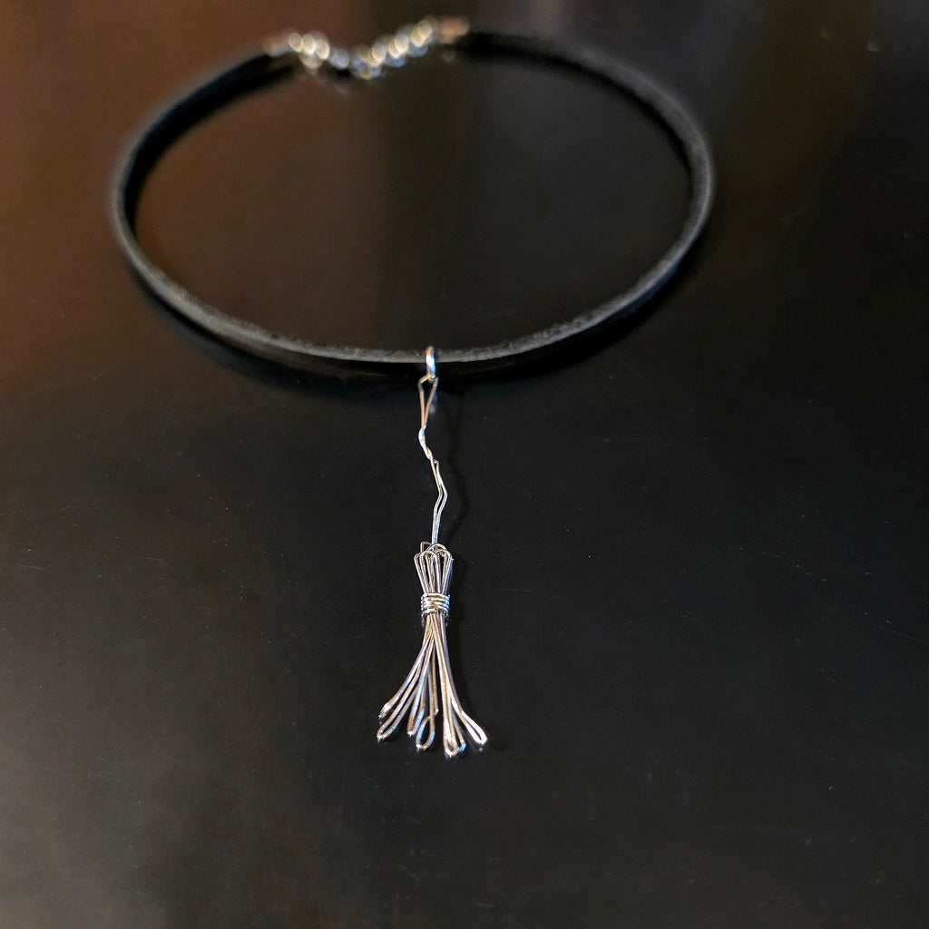 Witch's Broom Guitar String and Black Leather Choker on Black Background