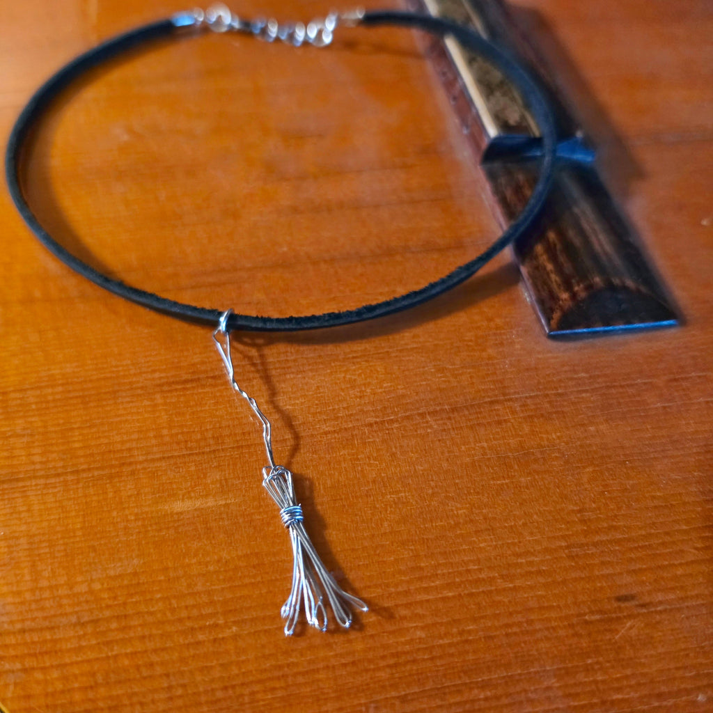 Witch's Broom Guitar String and Black Leather Choker on Guitar