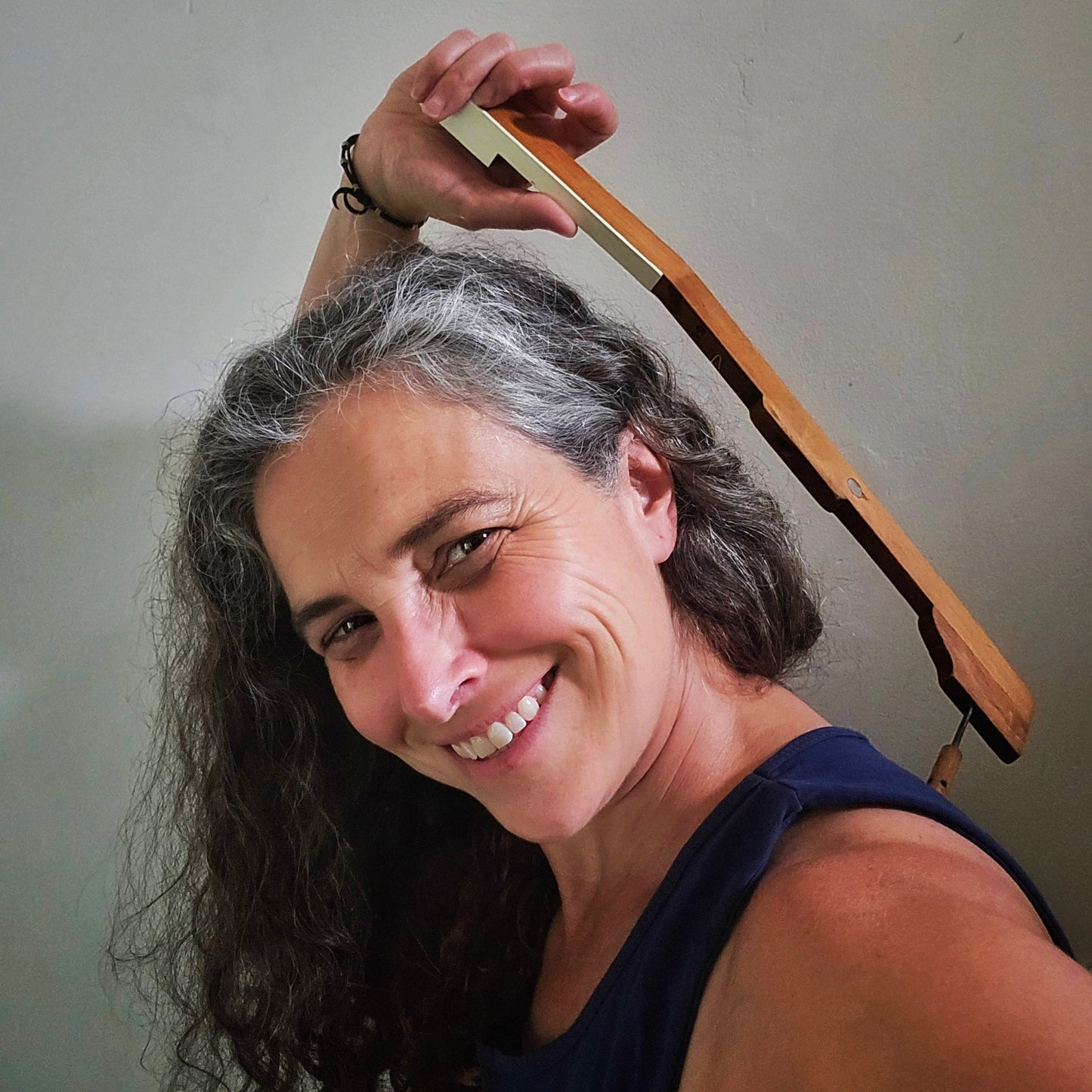 Woman using an upcycled piano key backscratcher