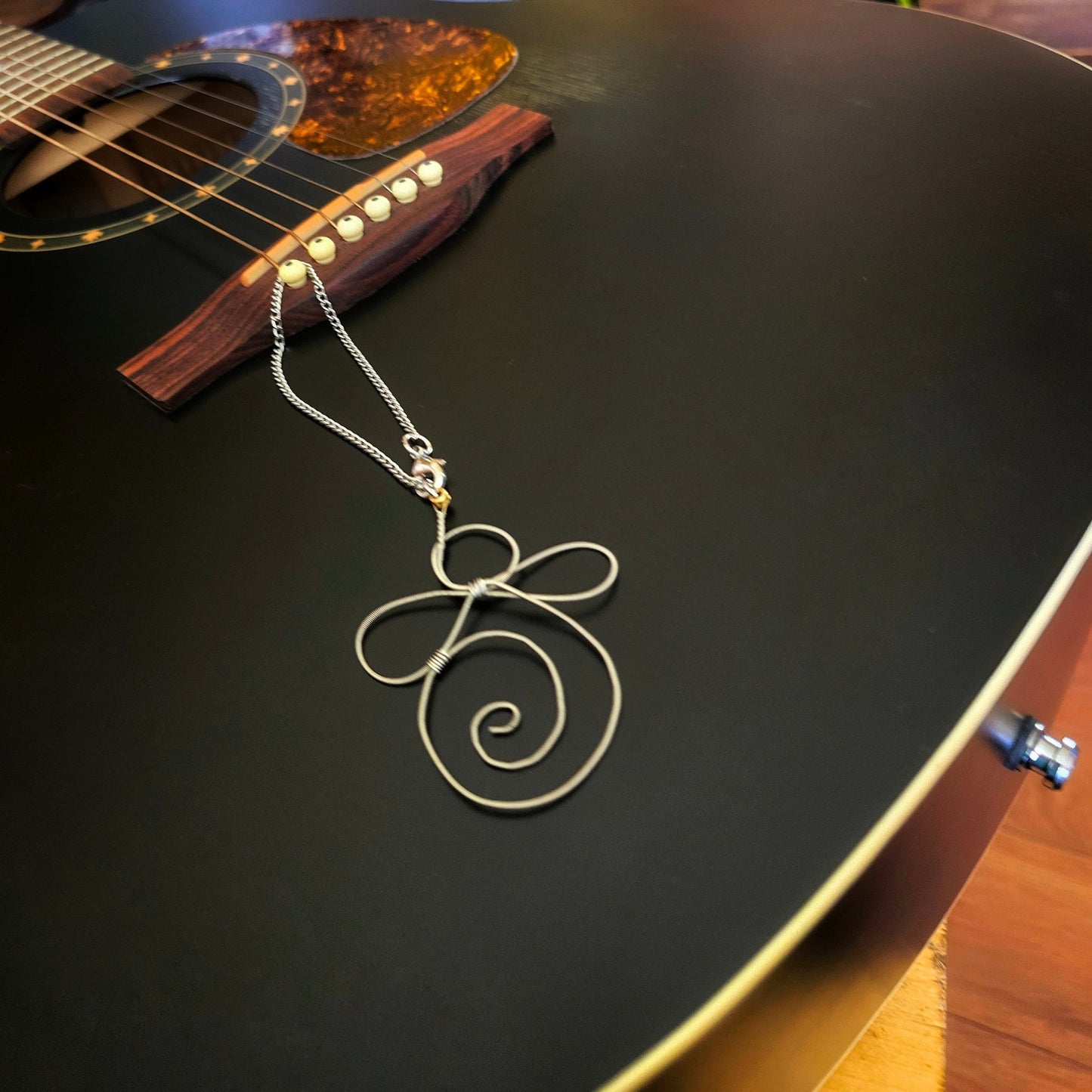 guitar string guardian angel decoration on a black guitar