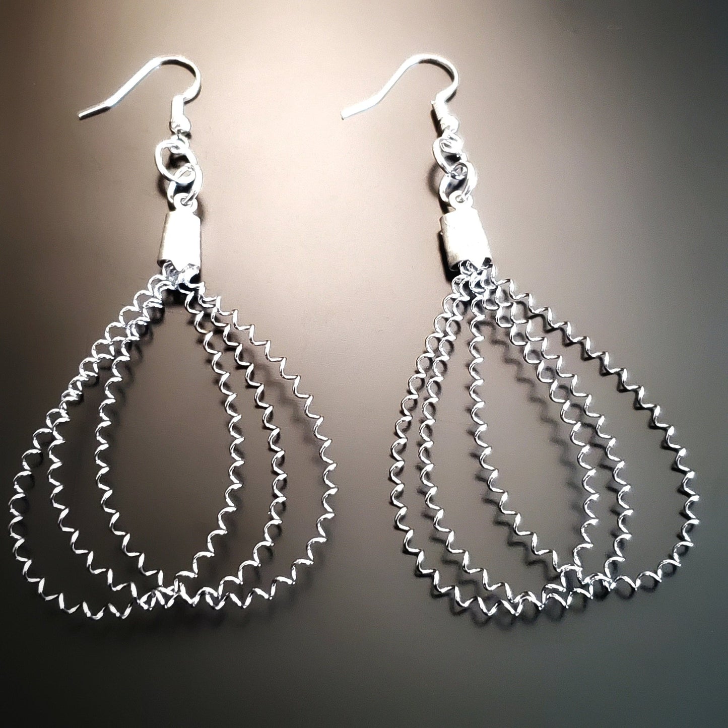 snare drum string teardrop style silver earrings