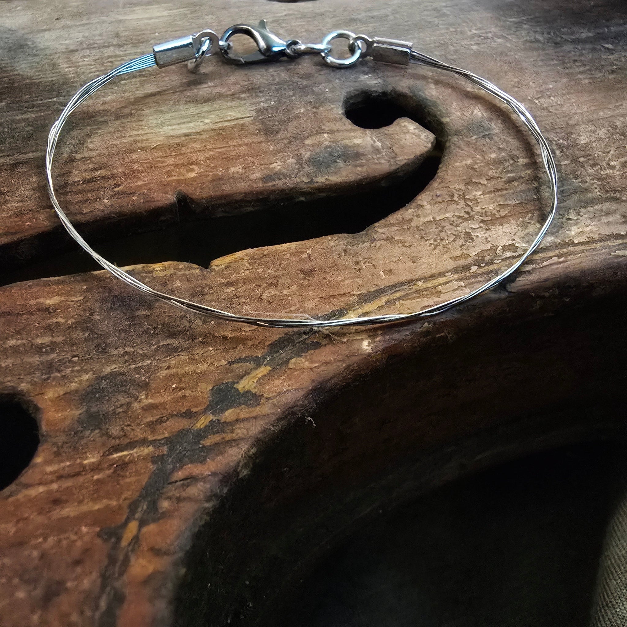 closeup of violin string bracelet on f holes of violin